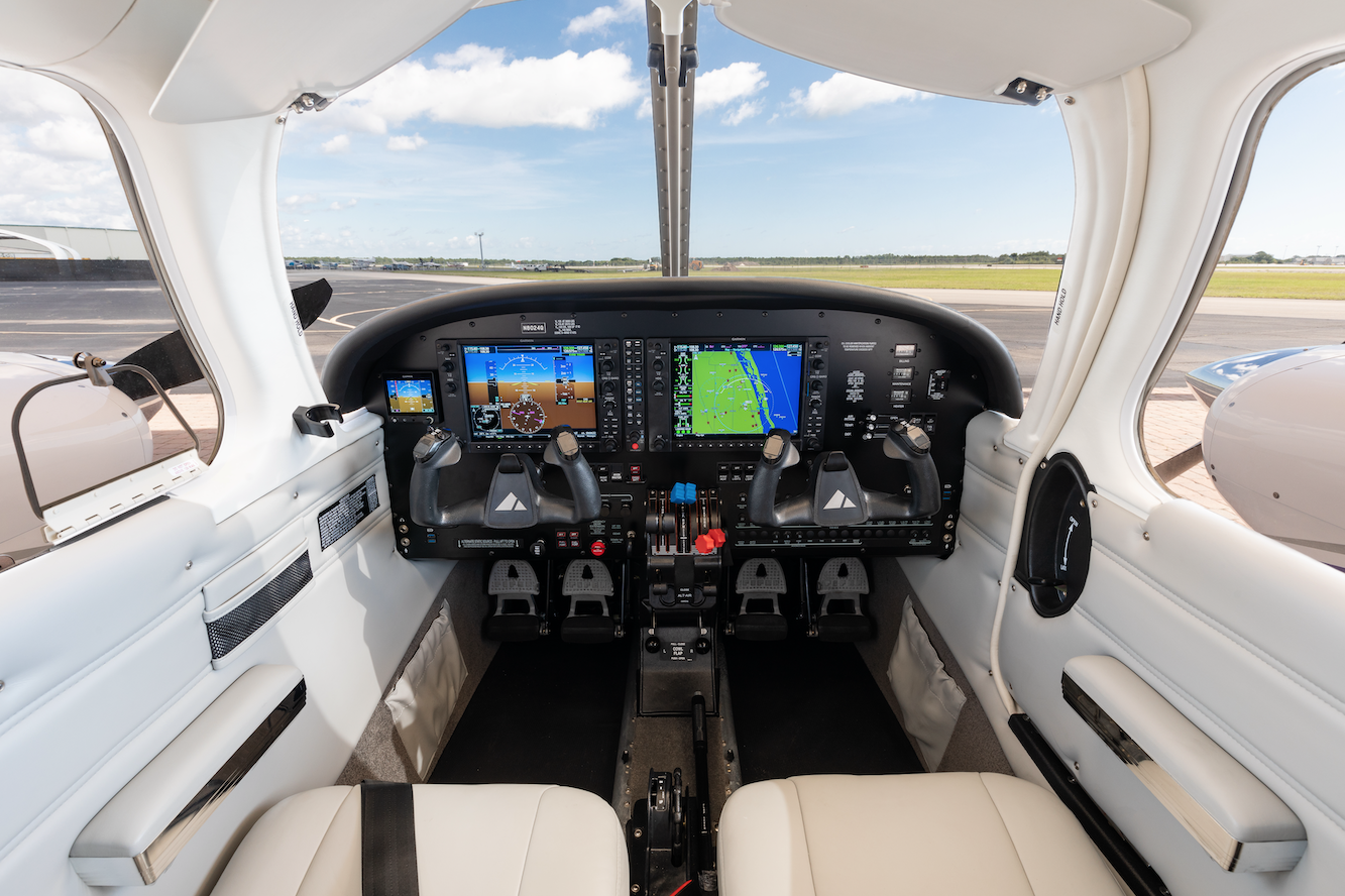 Interior view of the Piper Seminole cockpit featuring dual yokes, Garmin G1000 avionics displays and flight control panels.